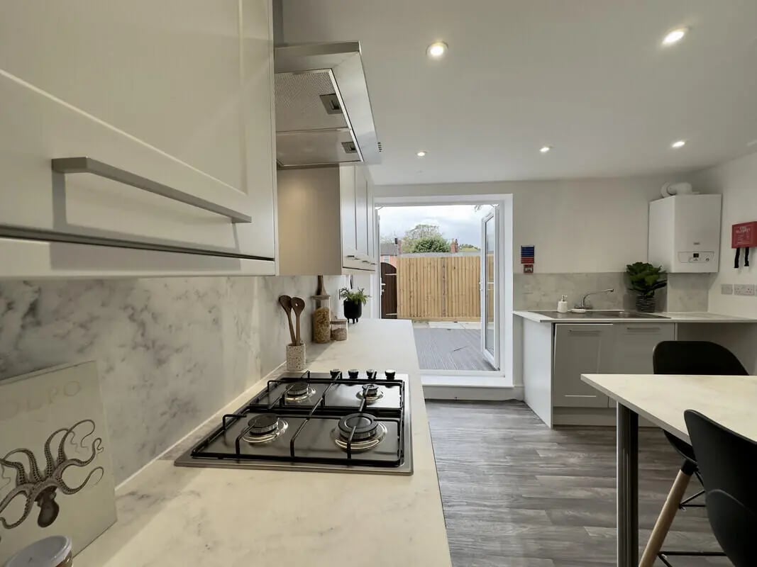 Gas hob marble countertop wooden deck patio kitchen at 6 Bedroom House at 43, Monks Road in Lincoln Student Accommodation