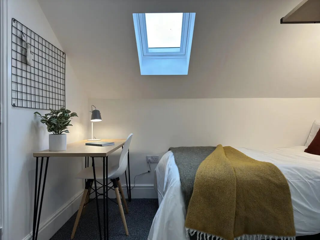 Desk plant lamp chair bed throws bedroom at 6 Bedroom House at 43, Monks Road in Lincoln Student Accommodation