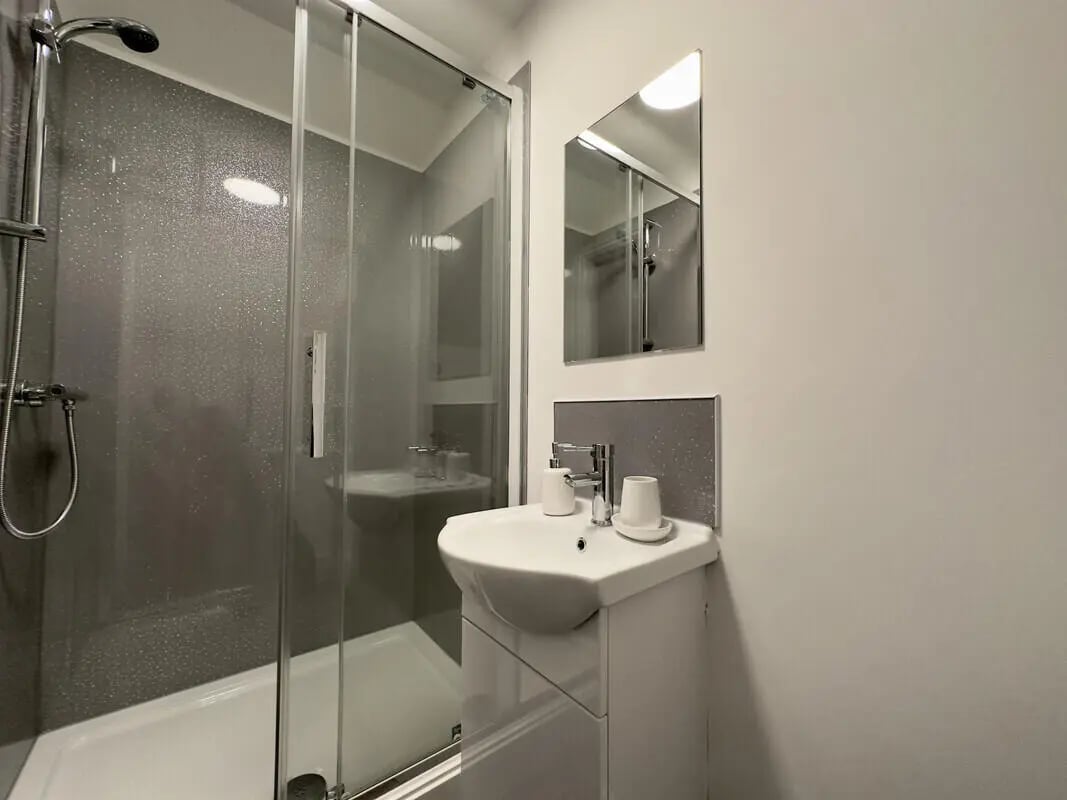 Shower stall sink and mirror student bathroom at 6 Bedroom House at 43, Monks Road in Lincoln Student Accommodation
