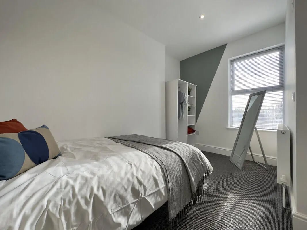 Bed pillows wardrobe mirror radiator bedroom at 6 Bedroom House at 43, Monks Road in Lincoln Student Accommodation