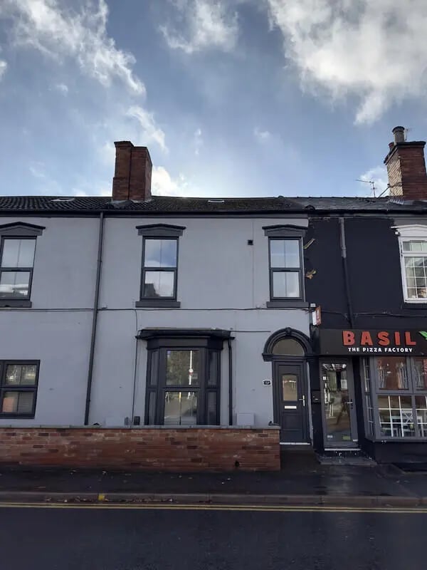 Terraced house with bay windows and pizza shop exterior at 6 Bedroom House at 43, Monks Road in Lincoln Student Accommodation