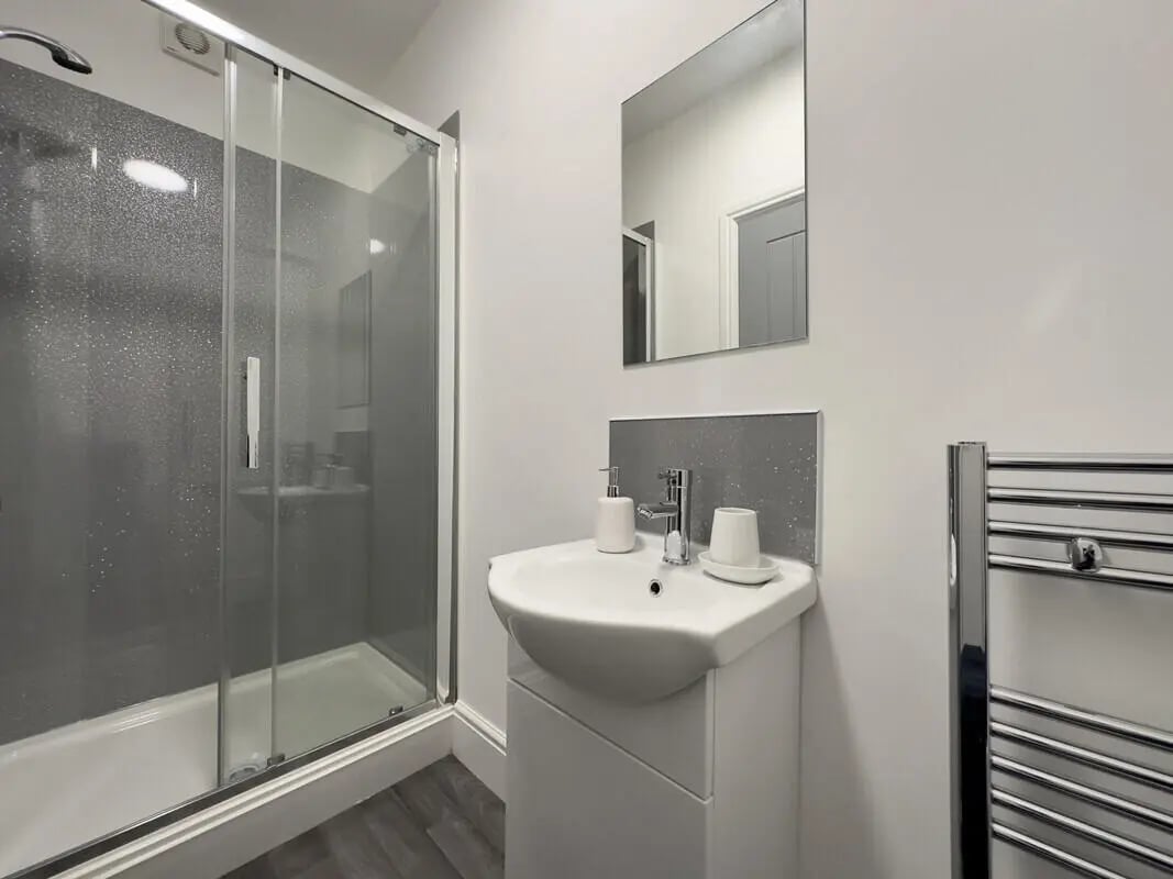 Shower sink mirror and towel rail bathroom at 6 Bedroom House at 45, Monks Road in Lincoln Student Accommodation