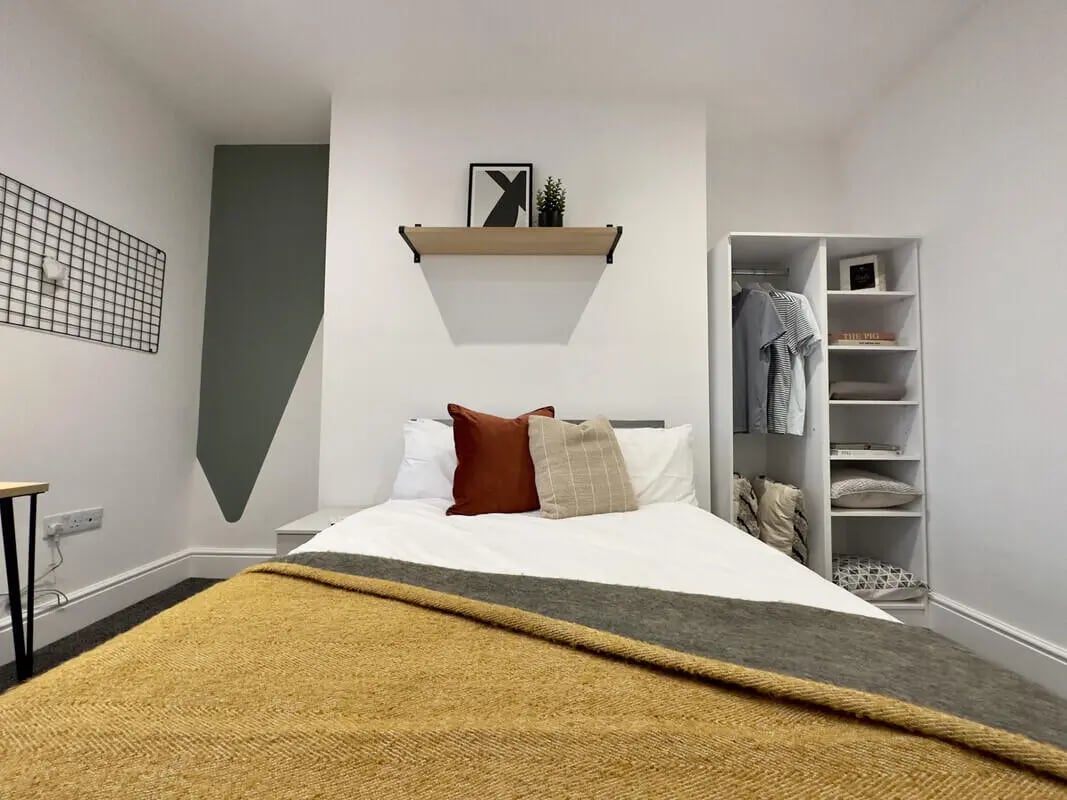 Bed with pillows and throw blanket bedroom at 6 Bedroom House at 45, Monks Road in Lincoln Student Accommodation
