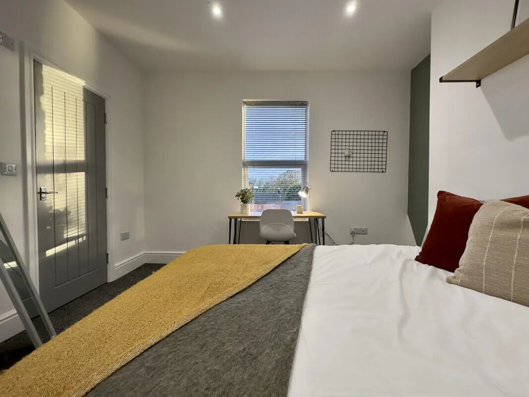 Bed desk chair plant and window bedroom at 6 Bedroom House at 45, Monks Road in Lincoln Student Accommodation