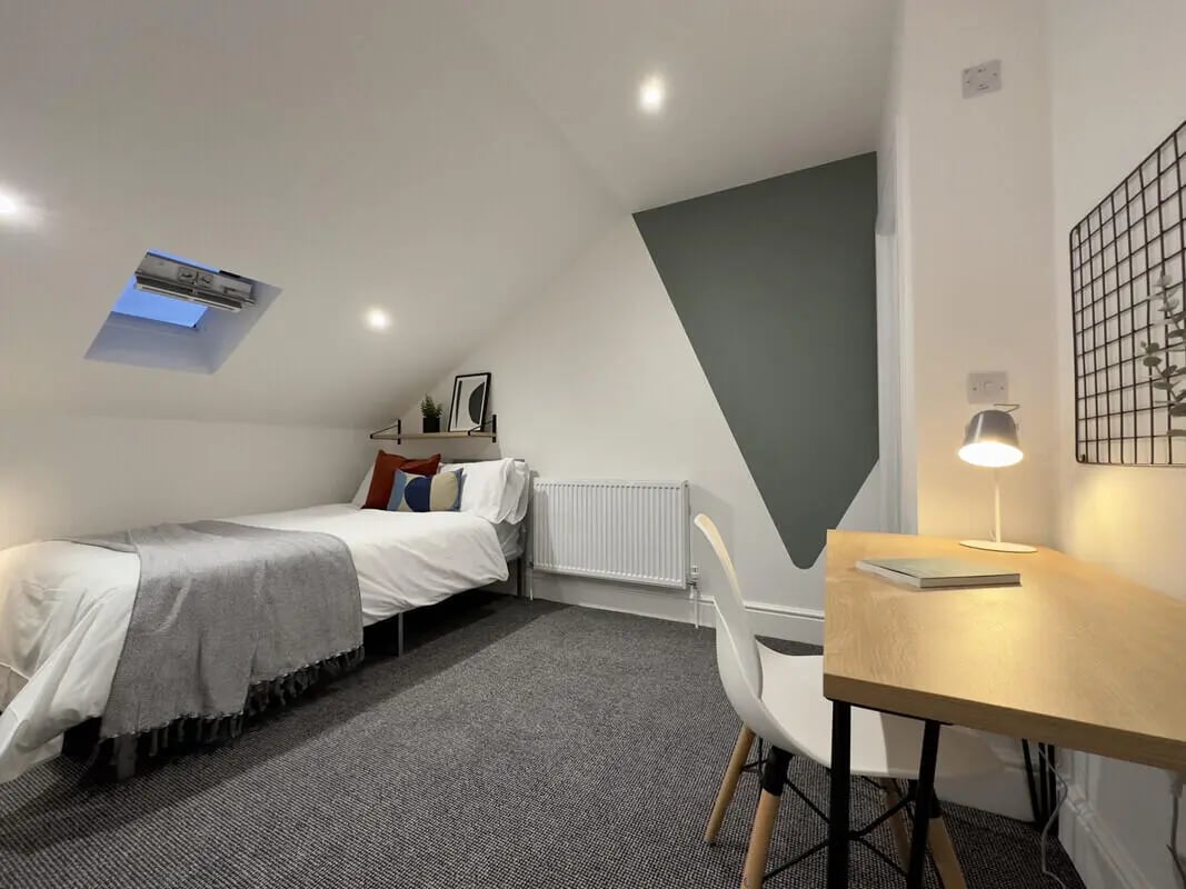 Bed desk chair and skylight bedroom at 6 Bedroom House at 45, Monks Road in Lincoln Student Accommodation