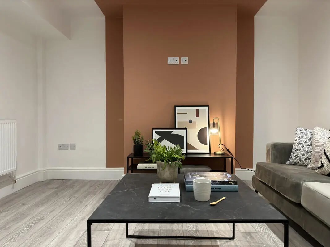 Coffee table books plants lamp sofa living room at 6 Bedroom House at 45, Monks Road in Lincoln Student Accommodation
