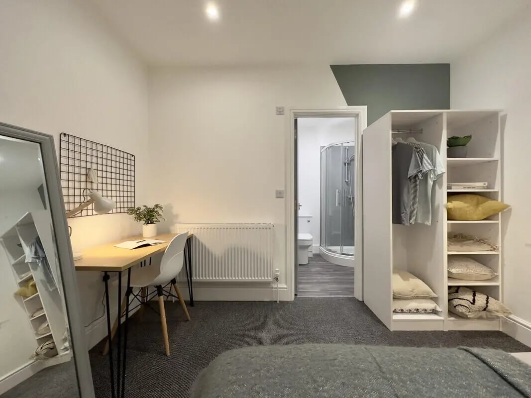 Desk mirror wardrobe open door bathroom Bedroom at 6 Bedroom House at 45, Monks Road in Lincoln Student Accommodation