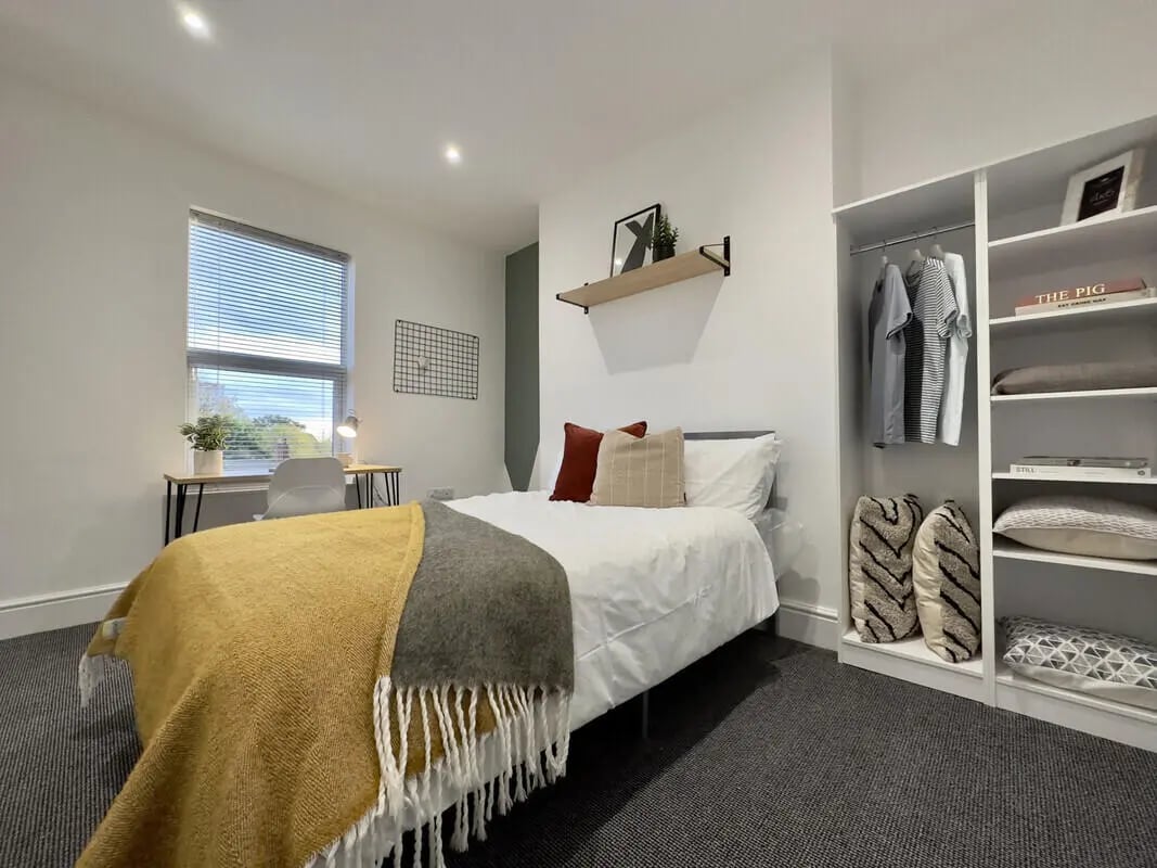 Bed desk closet and bed Bedroom at 6 Bedroom House at 45, Monks Road in Lincoln Student Accommodation