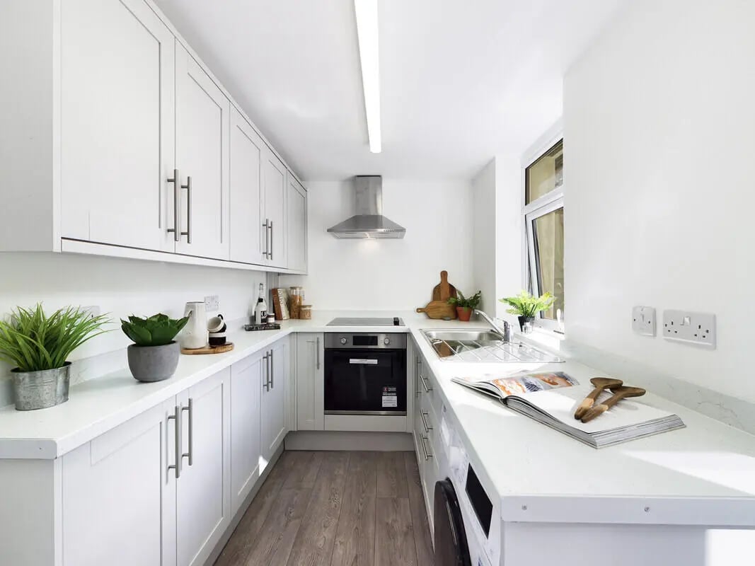 White cabinets stove oven sink book kitchen at 6 Bedroom House at 75A, West Parade in Lincoln Student Accommodation