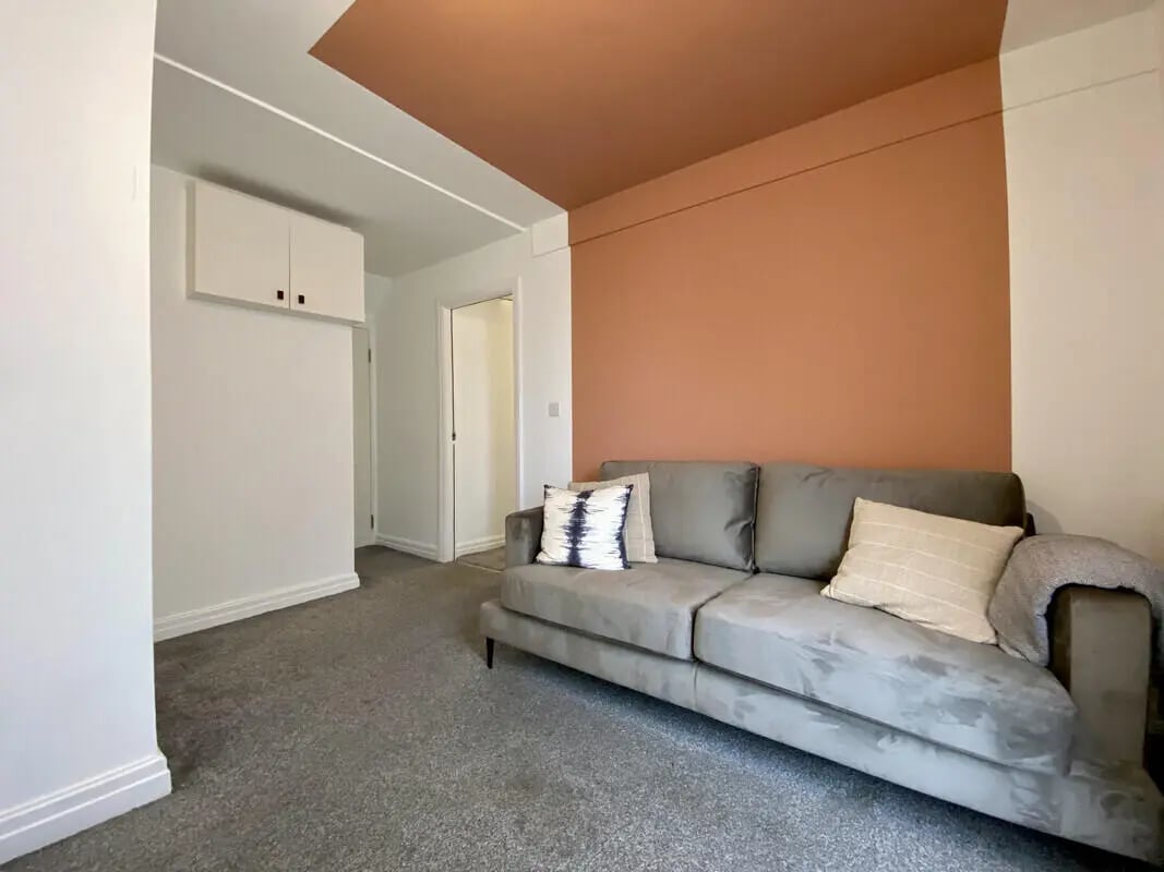 Grey sofa with pillows and blanket living room at 1 Bedroom House at Flat 3, 261, Edge Lane in Liverpool Student Accommodation