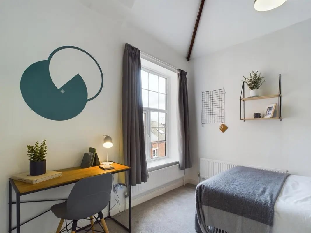Desk chair lamp bed and wall art bedroom at 9 Bedroom House at 19A, Bower Road in Sheffield Student Accommodation
