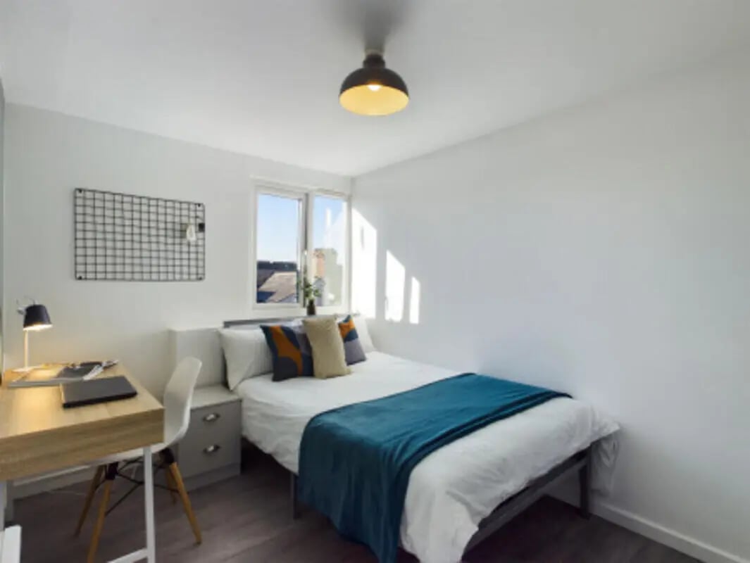 Bed desk chair grid wall window bedroom at 9 Bedroom House at 128, Uttoxeter New Road in Derby Student Accommodation