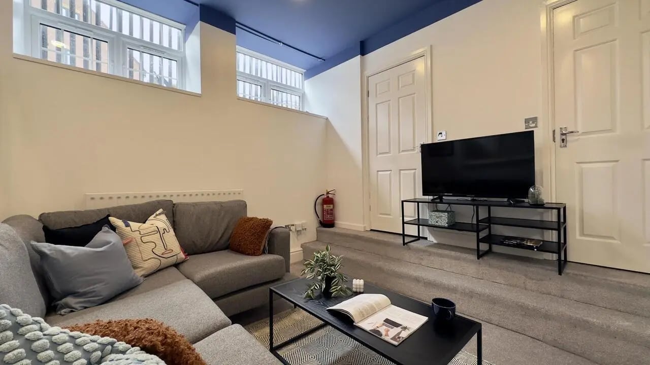 Grey sofa television and coffee table living room at 6 Bedroom House at 19C, Bower Road in Sheffield Student Accommodation