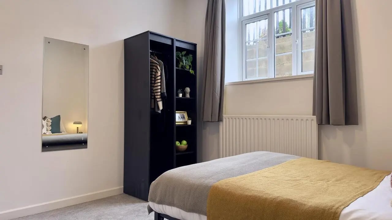 Black wardrobe mirror bed grey curtains bedroom at 6 Bedroom House at 19C, Bower Road in Sheffield Student Accommodation