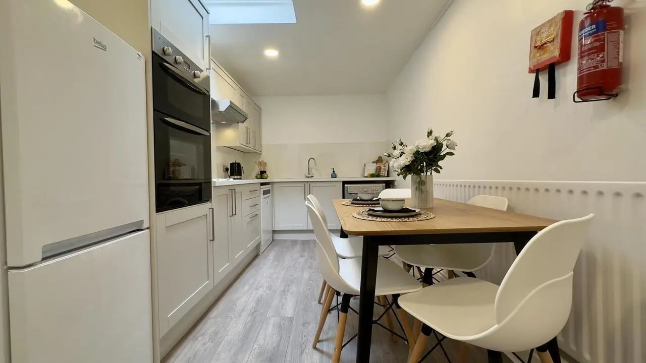 White fridge oven table chairs flowers kitchen at 6 Bedroom House at 19C, Bower Road in Sheffield Student Accommodation