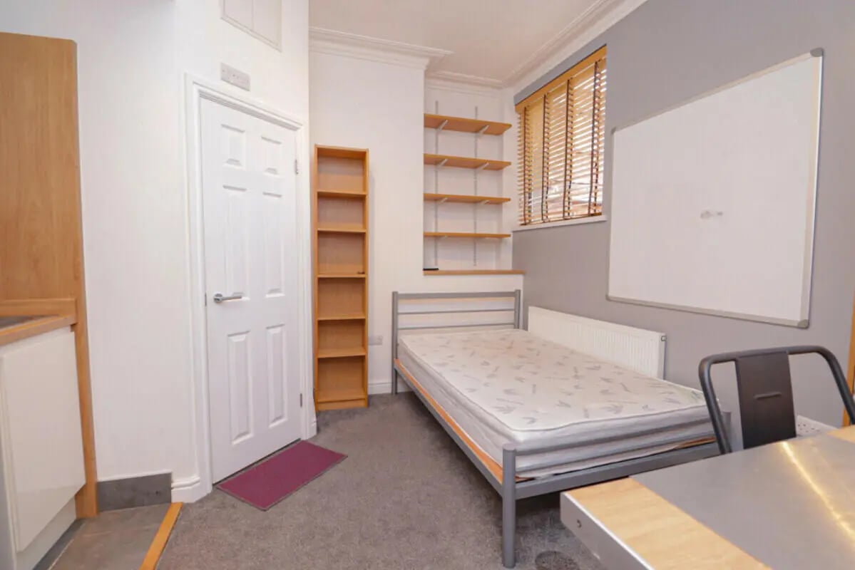 Bed bookshelves whiteboard door kitchen bedroom at 7 Bedroom House at 106, Yarborough Road in Lincoln Student Accommodation