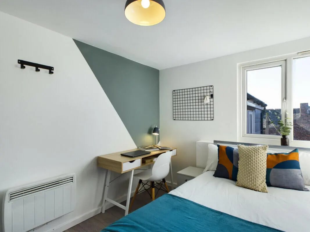 Bed desk lamp pillows window bedroom at 4 Bedroom House at 75, Saxony Road in Liverpool Student Accommodation