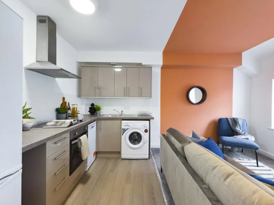 Modern kitchen and living area with sofa Image at 6 Bedroom House at 36, Brae Street in Liverpool Student Accommodation
