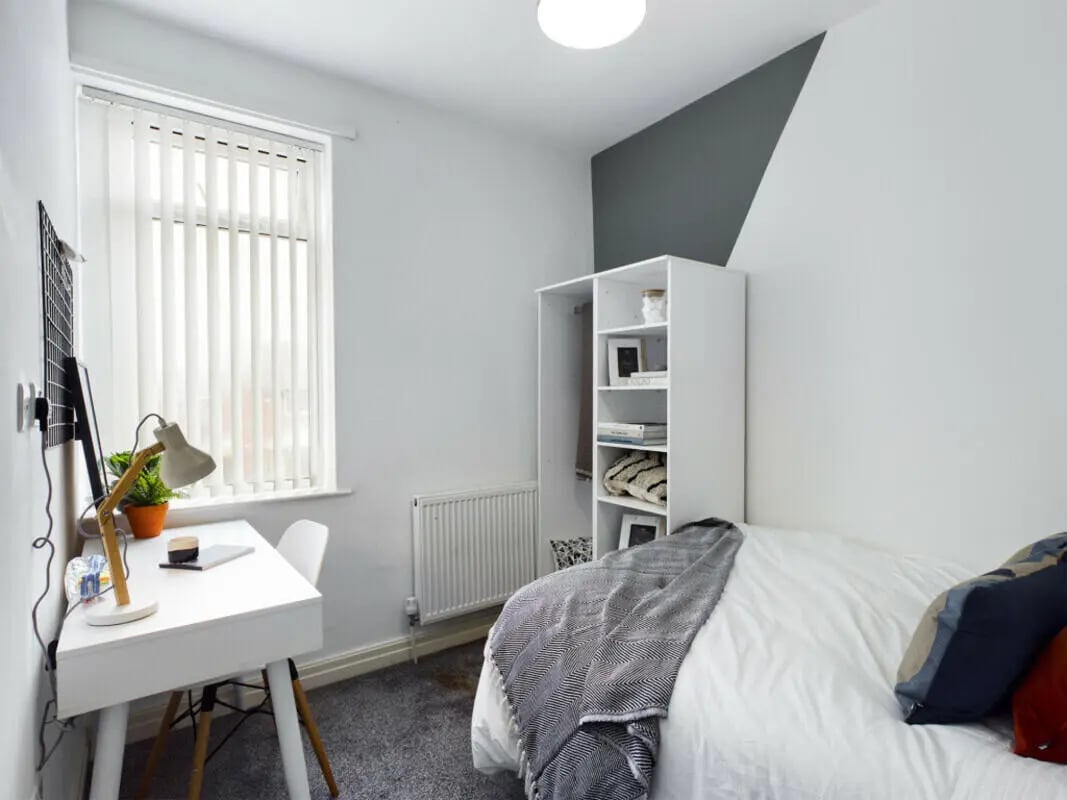 Bed desk lamp shelf window and radiator bedroom at 6 Bedroom House at 36, Brae Street in Liverpool Student Accommodation