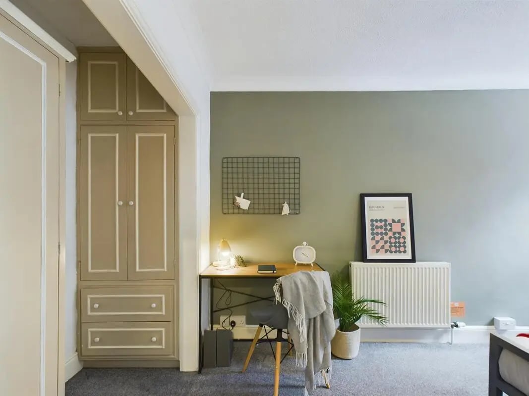 Desk chair radiator poster and wardrobe study area at 4 Bedroom House at 11, Charles Street West in Lincoln Student Accommodation