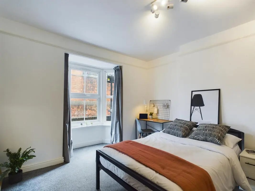 Bed desk plant and framed art bedroom at 4 Bedroom House at 11, Charles Street West in Lincoln Student Accommodation