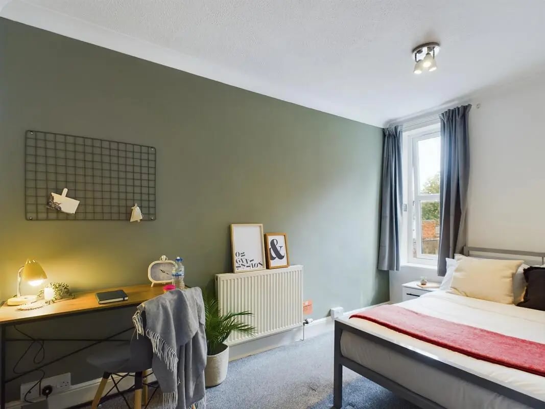 Desk chair bed and radiator bedroom at 4 Bedroom House at 11, Charles Street West in Lincoln Student Accommodation