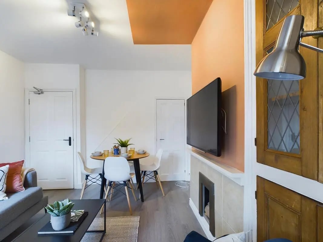 Dining table chairs television living area at 4 Bedroom House at 11, Charles Street West in Lincoln Student Accommodation