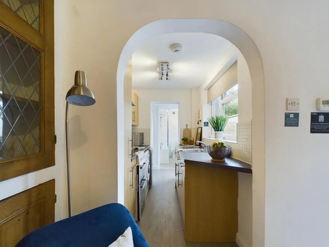 Archway opening to a long kitchen with appliances kitchen at 4 Bedroom House at 11, Charles Street West in Lincoln Student Accommodation