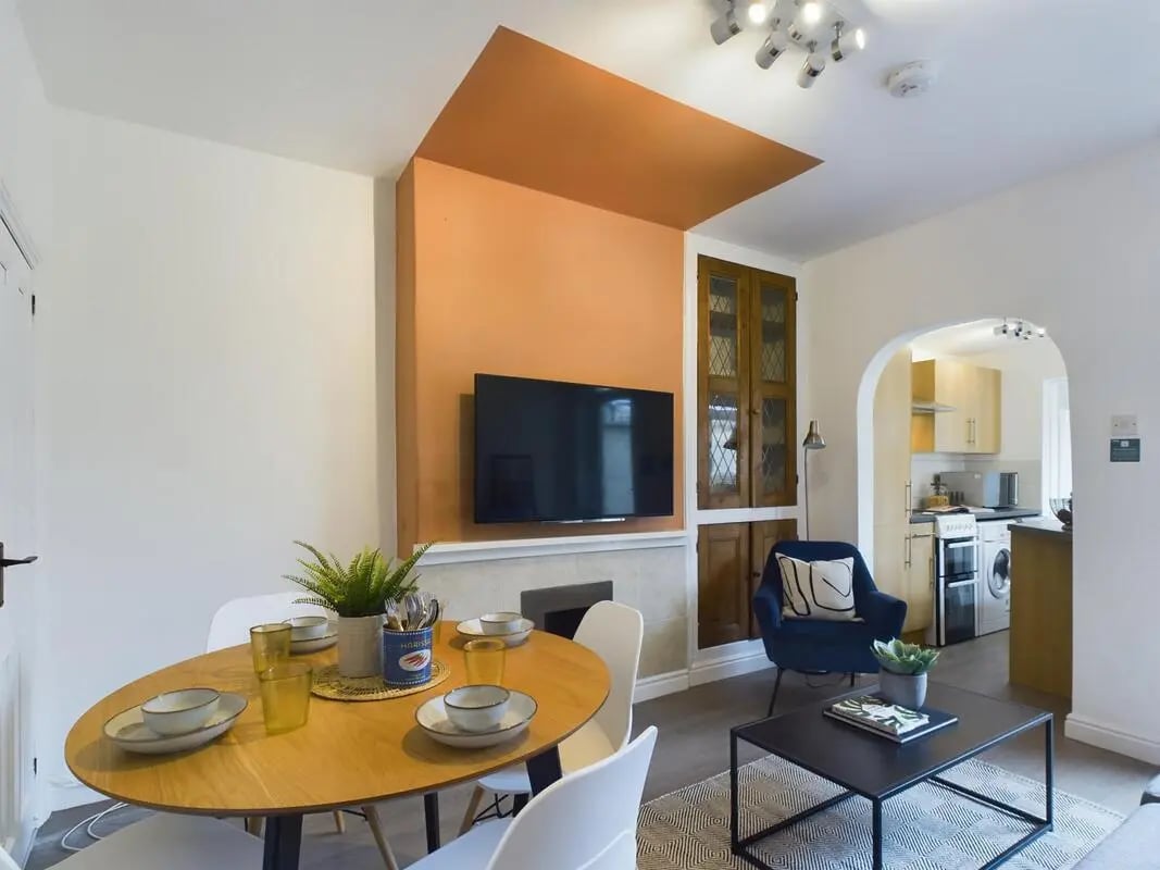 Dining table with chairs and TV living room at 4 Bedroom House at 11, Charles Street West in Lincoln Student Accommodation