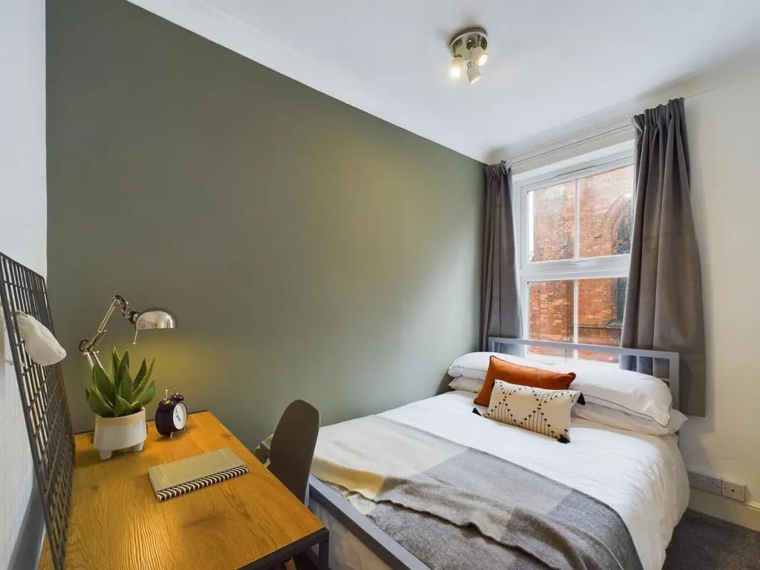 Desk with lamp plant and bed bedroom at 4 Bedroom House at 11, Charles Street West in Lincoln Student Accommodation