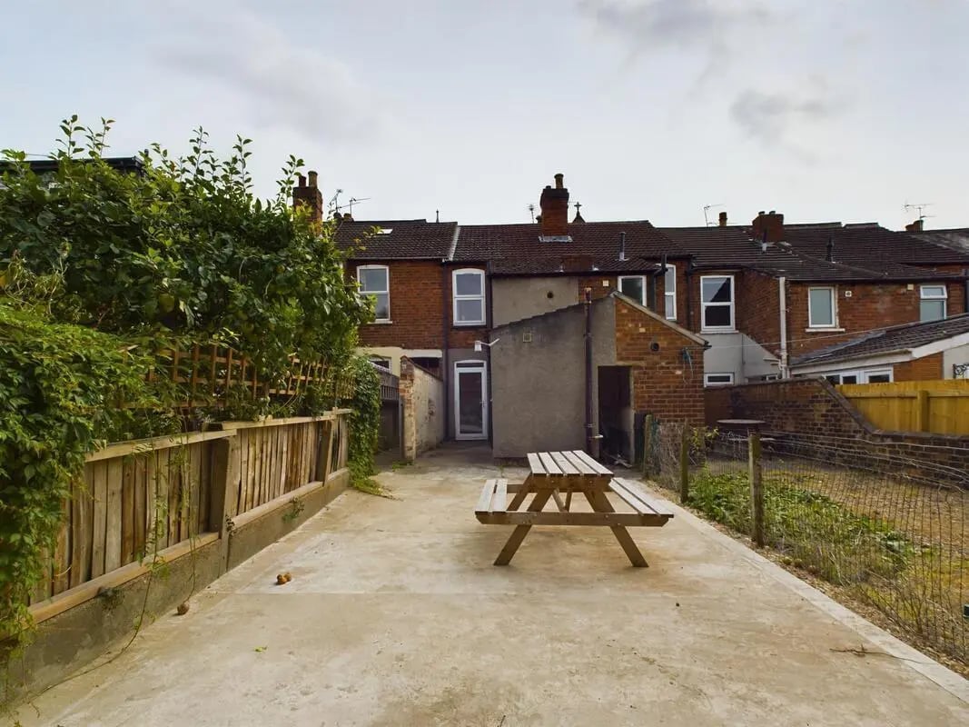 Wooden picnic table in paved yard exterior at 4 Bedroom House at 11, Charles Street West in Lincoln Student Accommodation