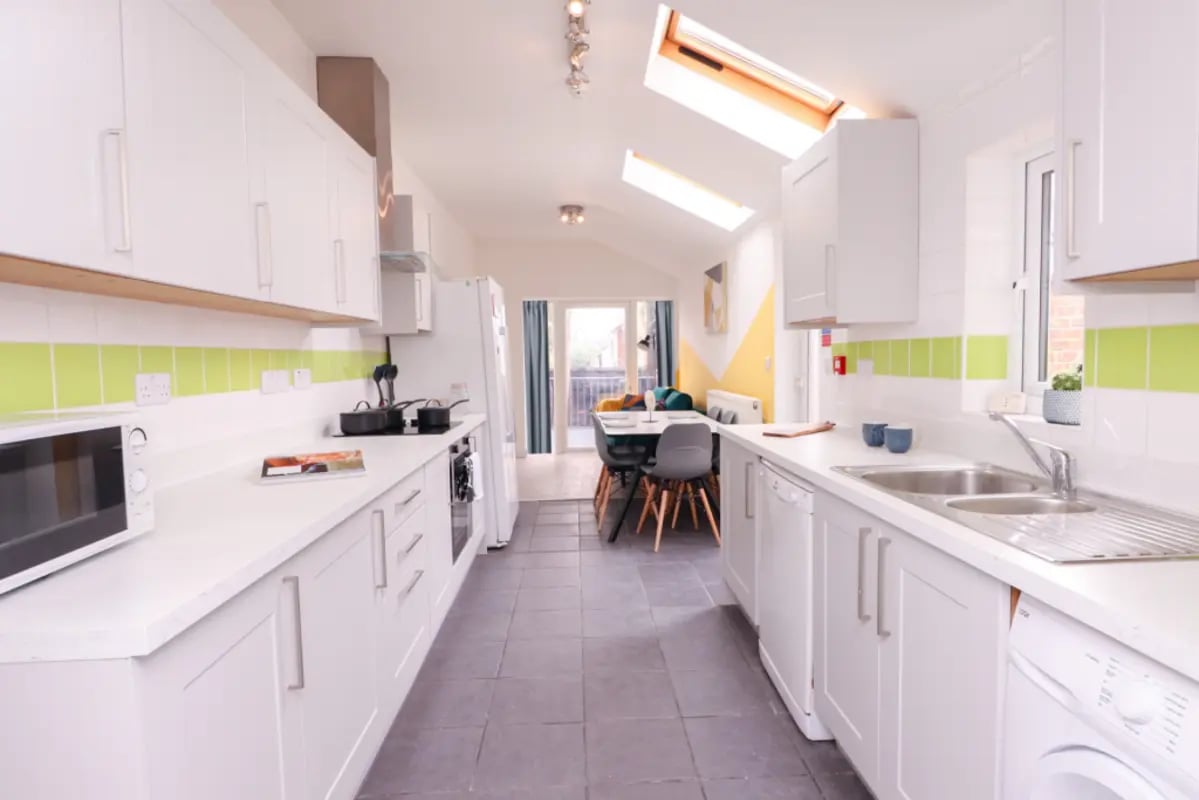 White kitchen with oven microwave dining table kitchen at 5 Bedroom House at 99, Monks Road in Lincoln Student Accommodation