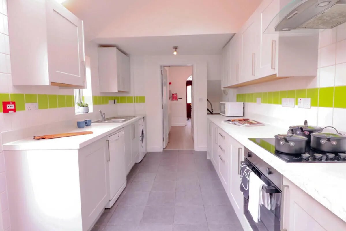 White cabinets dishwasher washing machine pots kitchen at 5 Bedroom House at 99, Monks Road in Lincoln Student Accommodation