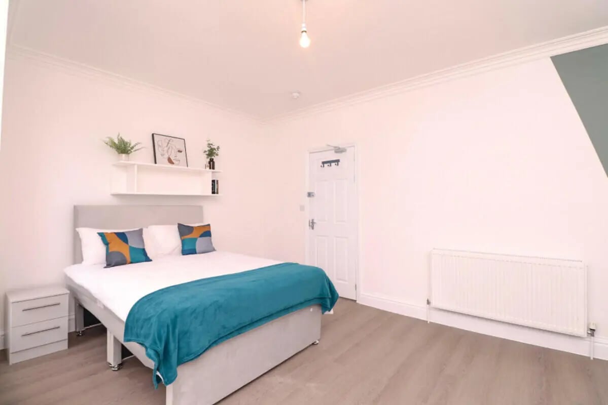 Bed pillows shelf and nightstand bedroom at 5 Bedroom House at 99, Monks Road in Lincoln Student Accommodation