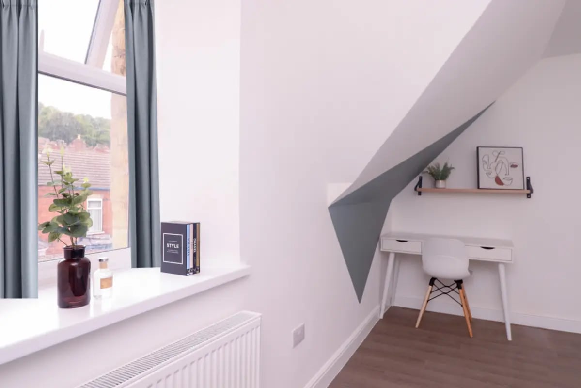 Desk plant books and art study area at 5 Bedroom House at 99, Monks Road in Lincoln Student Accommodation
