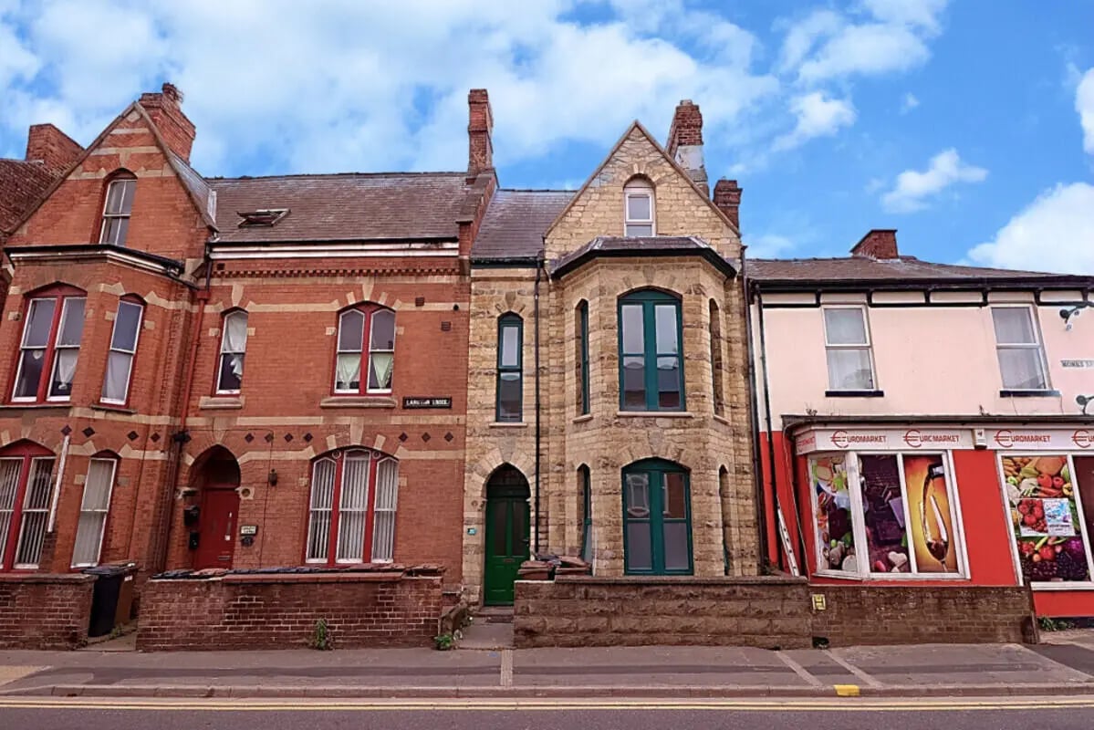 Townhouses with shops below exterior at 5 Bedroom House at 99, Monks Road in Lincoln Student Accommodation