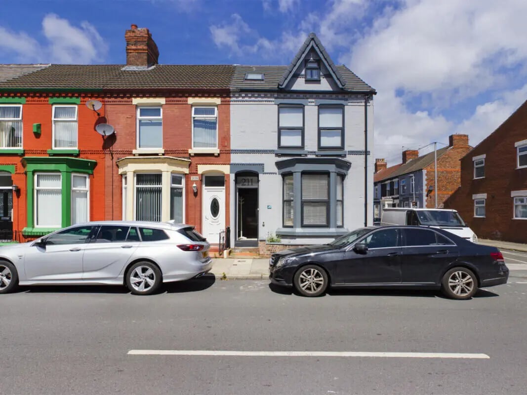 Two cars parked outside residential terraced houses exterior at 8 Bedroom House at 211, Molyneux Road in Liverpool Student Accommodation