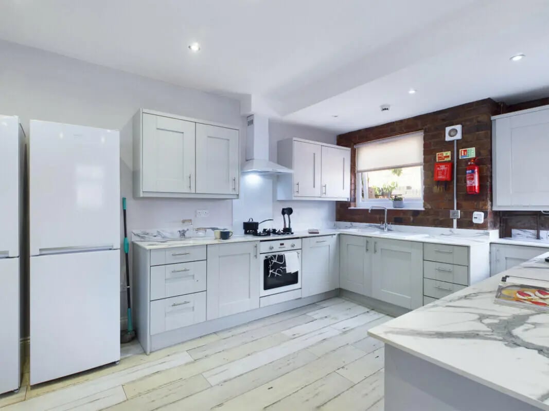 White refrigerators stove cabinets sink kitchen at 8 Bedroom House at 211, Molyneux Road in Liverpool Student Accommodation