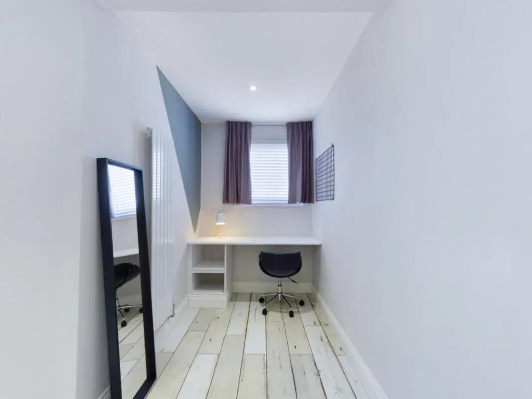 Desk chair mirror radiator and lamp study area at 8 Bedroom House at 211, Molyneux Road in Liverpool Student Accommodation