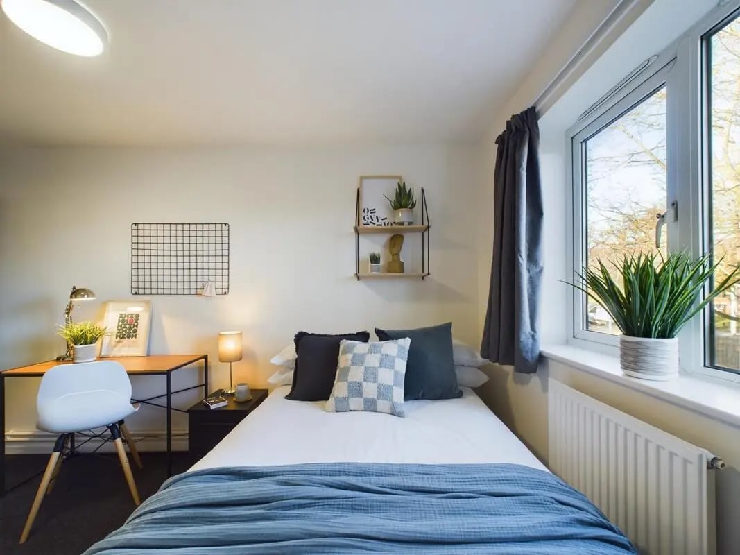 Bed desk chair pillows shelves window bedroom at 4 Bedroom House at 11, Brookside in Derby Student Accommodation