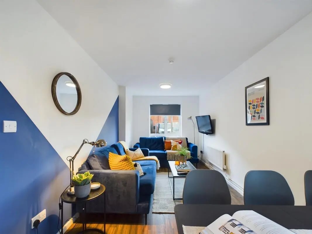 Blue sofas coffee table lamp wall art living room at 4 Bedroom House at 11, Brookside in Derby Student Accommodation