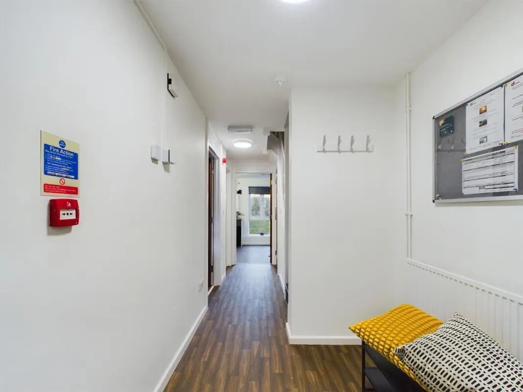 Hallway with fire alarm and bench hallway at 4 Bedroom House at 11, Brookside in Derby Student Accommodation