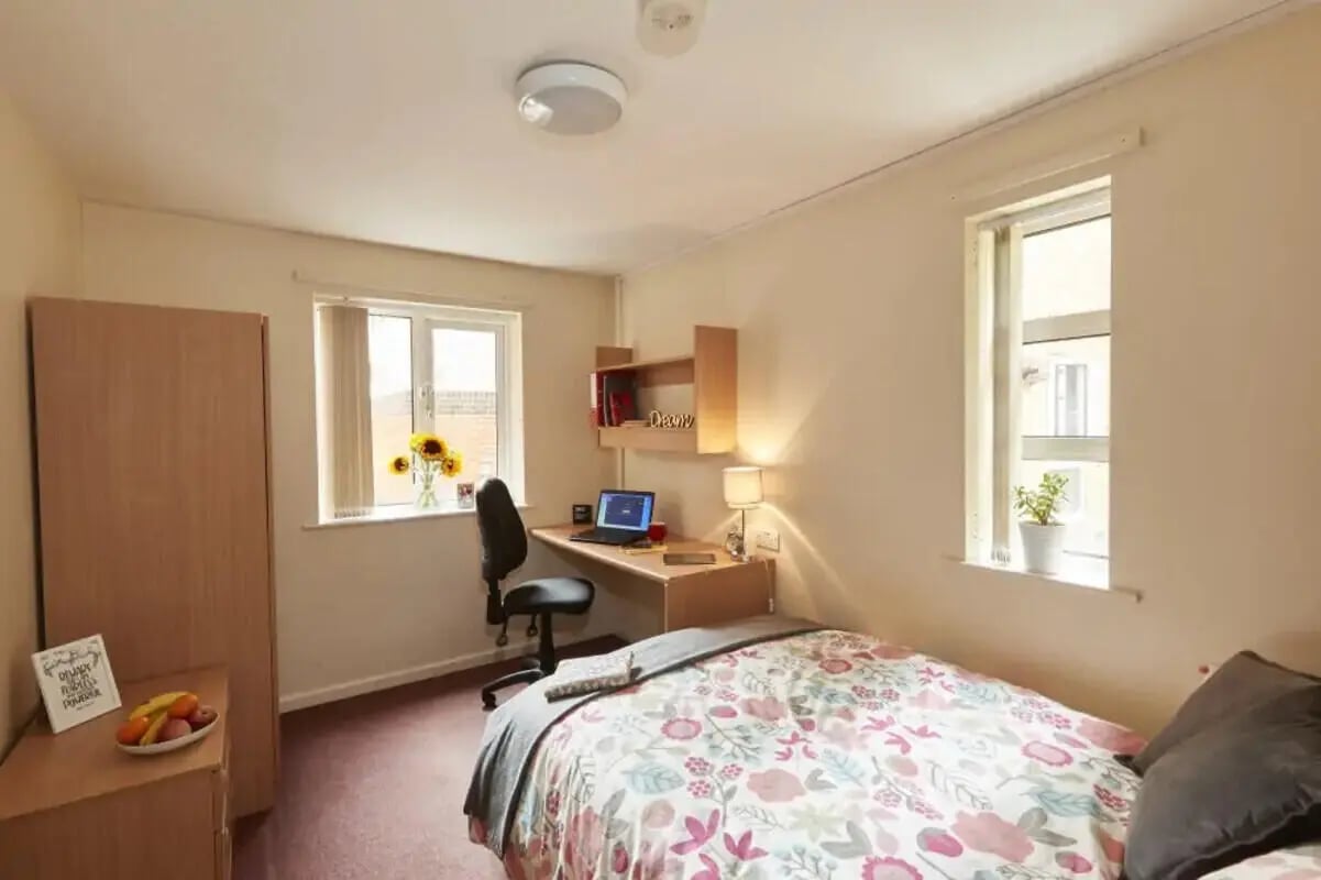 Bed desk wardrobe fruit bowl sunflowers bedroom at 4 Bedroom House at 15, Brookside in Derby Student Accommodation