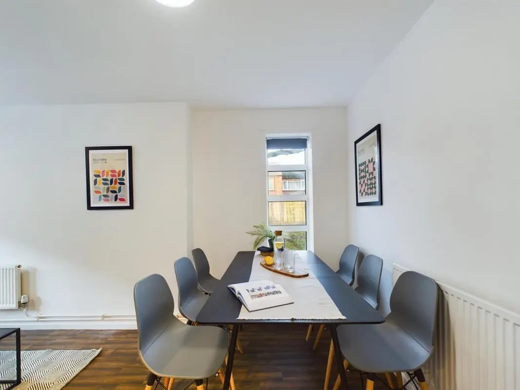 Dining table with chairs and artwork Dining area at 6 Bedroom House at 24, Brookside in Derby Student Accommodation