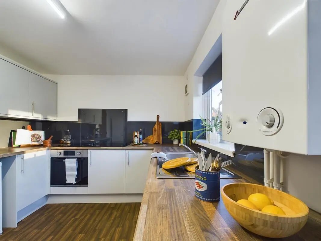 White cabinets oven sink with yellow plates kitchen at 6 Bedroom House at 25, Brookside in Derby Student Accommodation