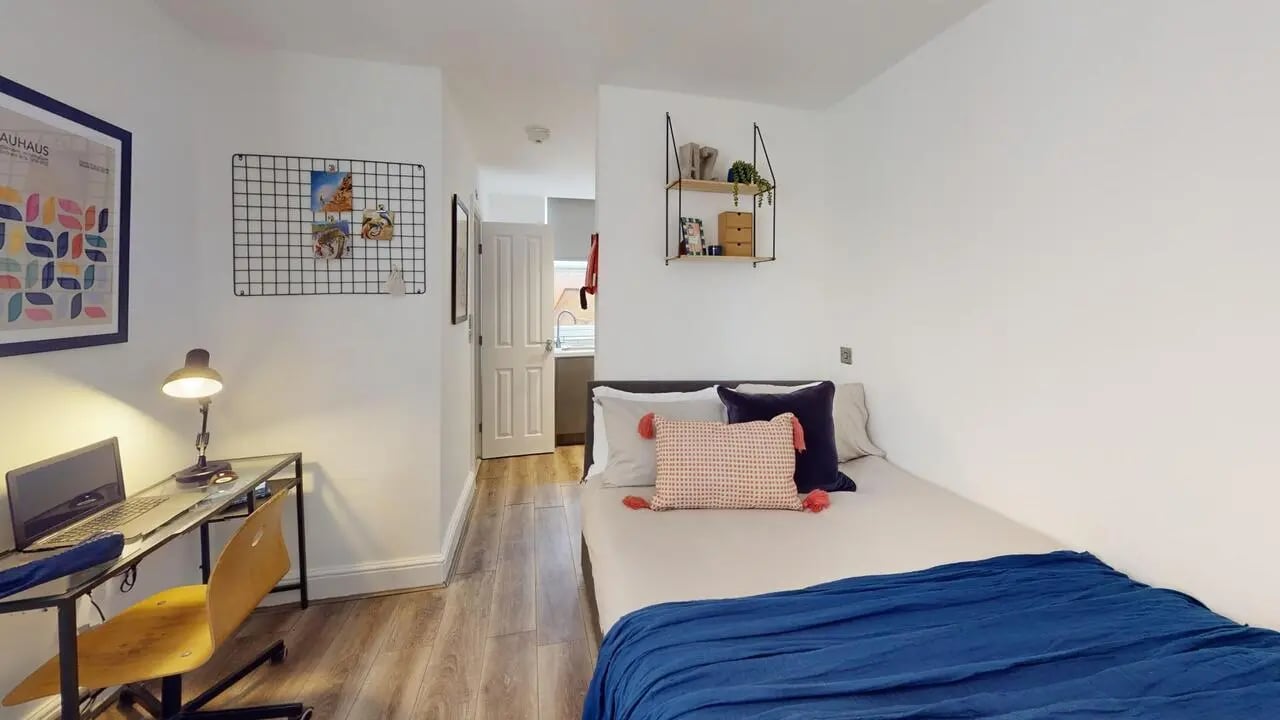 Desk with laptop bed with blue blanket Bedroom at 1 Bedroom House at Flat 3, 265, Edge Lane in Liverpool Student Accommodation