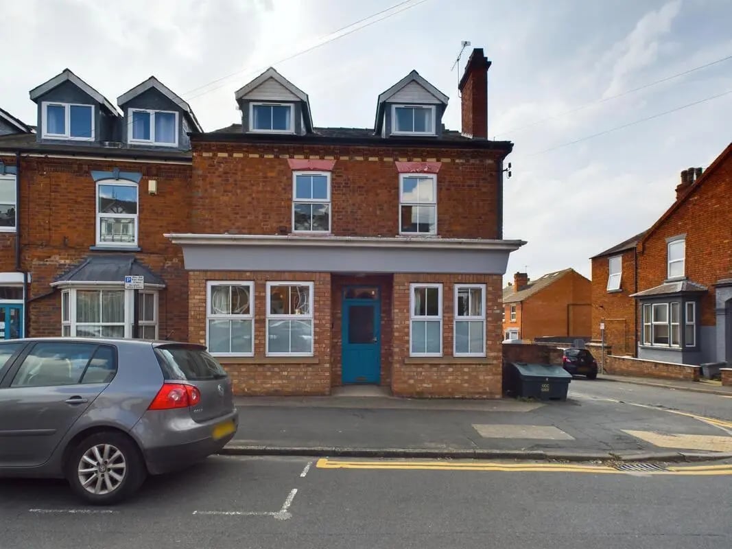 Brick building with blue door and windows exterior at 4 Bedroom House at 75, West Parade in Lincoln Student Accommodation