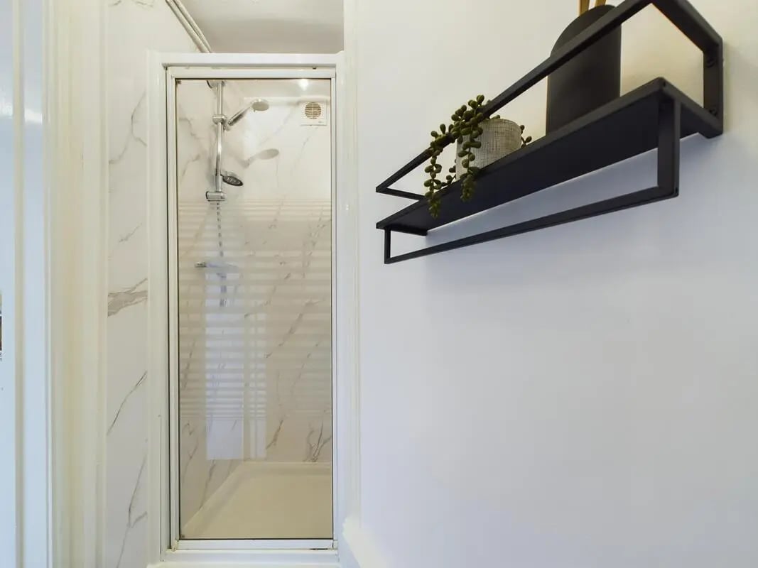 Shower stall with plant on shelf bathroom at 4 Bedroom House at 75, West Parade in Lincoln Student Accommodation