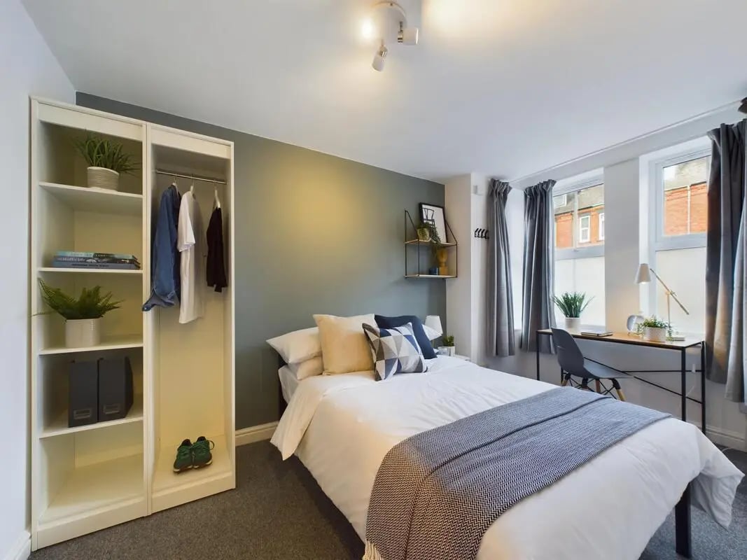 Bed with closet shelves desk and window bedroom at 4 Bedroom House at 75, West Parade in Lincoln Student Accommodation