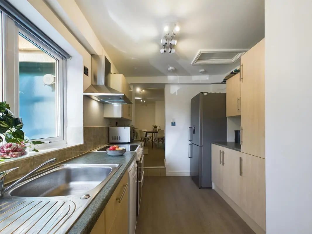 Sink microwave fridge cabinets kitchen at 4 Bedroom House at 75, West Parade in Lincoln Student Accommodation